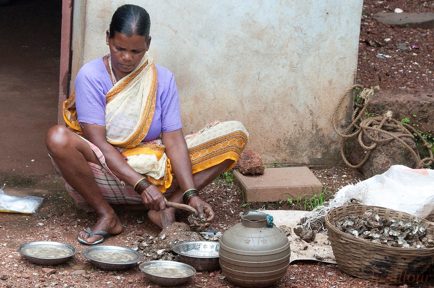 A woman with a basket of oysters in Goa, India